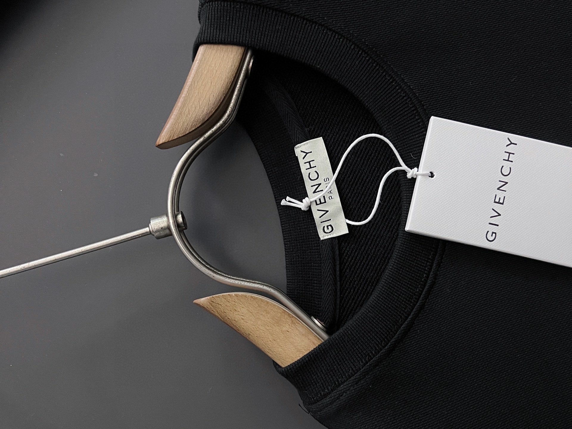 Black ribbed-collar sweatshirt with inside neck label and attached hang tag