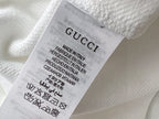 White sweatshirt care label inside neckline with Made in Italy text