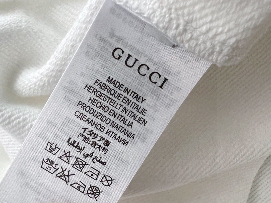 White sweatshirt care label inside neckline with Made in Italy text