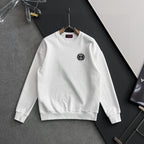 White crewneck sweatshirt with long sleeves and small circular Gucci logo patch