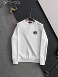 White crewneck sweatshirt with small circular Gucci logo patch on chest