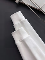 White sweatshirt ribbed cuffs and hem close-up