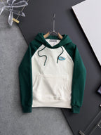 Green sleeves and white body hoodie with hood, drawstrings, and front kangaroo pocket