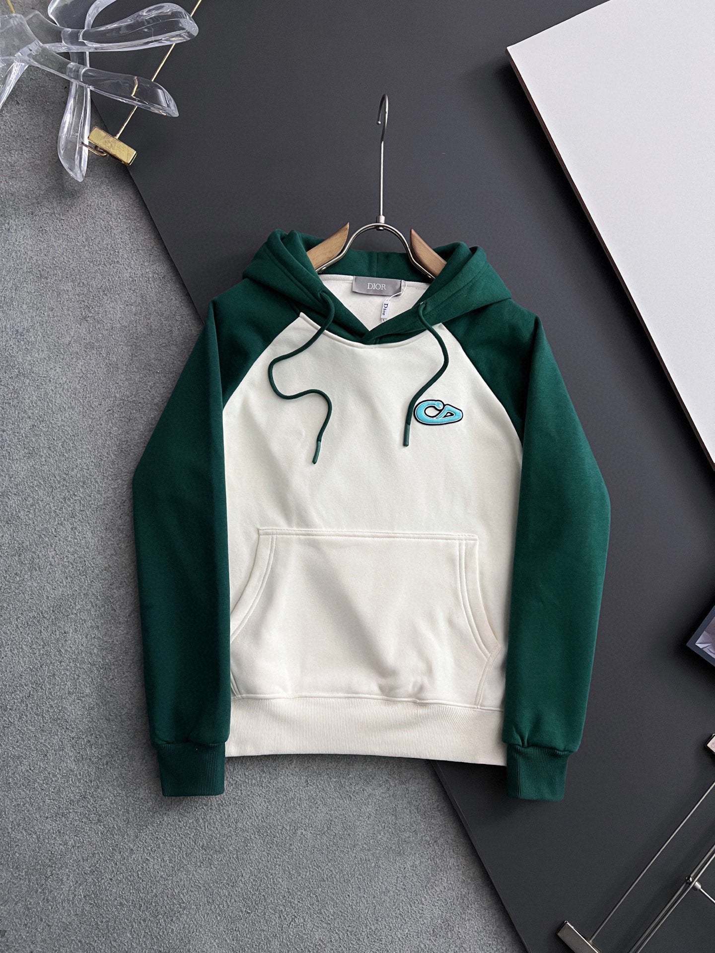 Green sleeves and white body hoodie with hood, drawstrings, and front kangaroo pocket