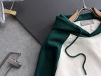 Green-and-white hoodie with drawstring hood and front kangaroo pocket