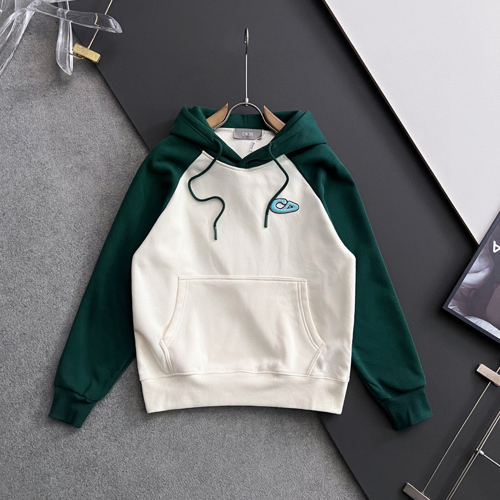 Two-tone hoodie with green sleeves, white front panel, hood, and kangaroo pocket