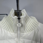 Long puffer jacket front close-up with off-white ribbed collar and zipper pull