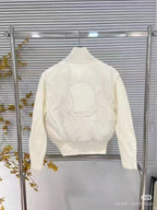Moncler padded jacket with ribbed turtleneck, front zipper, and knit cuffs, white
