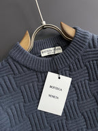 Dark blue ribbed knit sweater neckline with Bottega Veneta brand tag