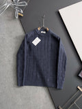 Dark blue textured knit sweater with crew neck and ribbed cuffs