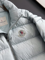 Moncler light puffer jacket with front zipper and round logo patch, close angle