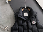 Black long Moncler puffer jacket with hood and crest patch on sleeve