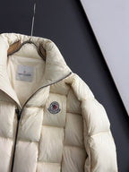Moncler long puffer jacket, cream, side view with circular chest logo patch