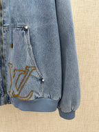 Light blue denim jacket pocket with gold LV embroidery and snap button