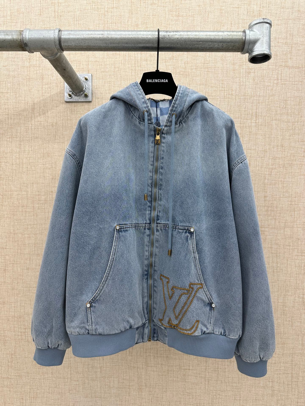 Light blue denim zip-up hoodie jacket with hood and front pockets, gold LV logo
