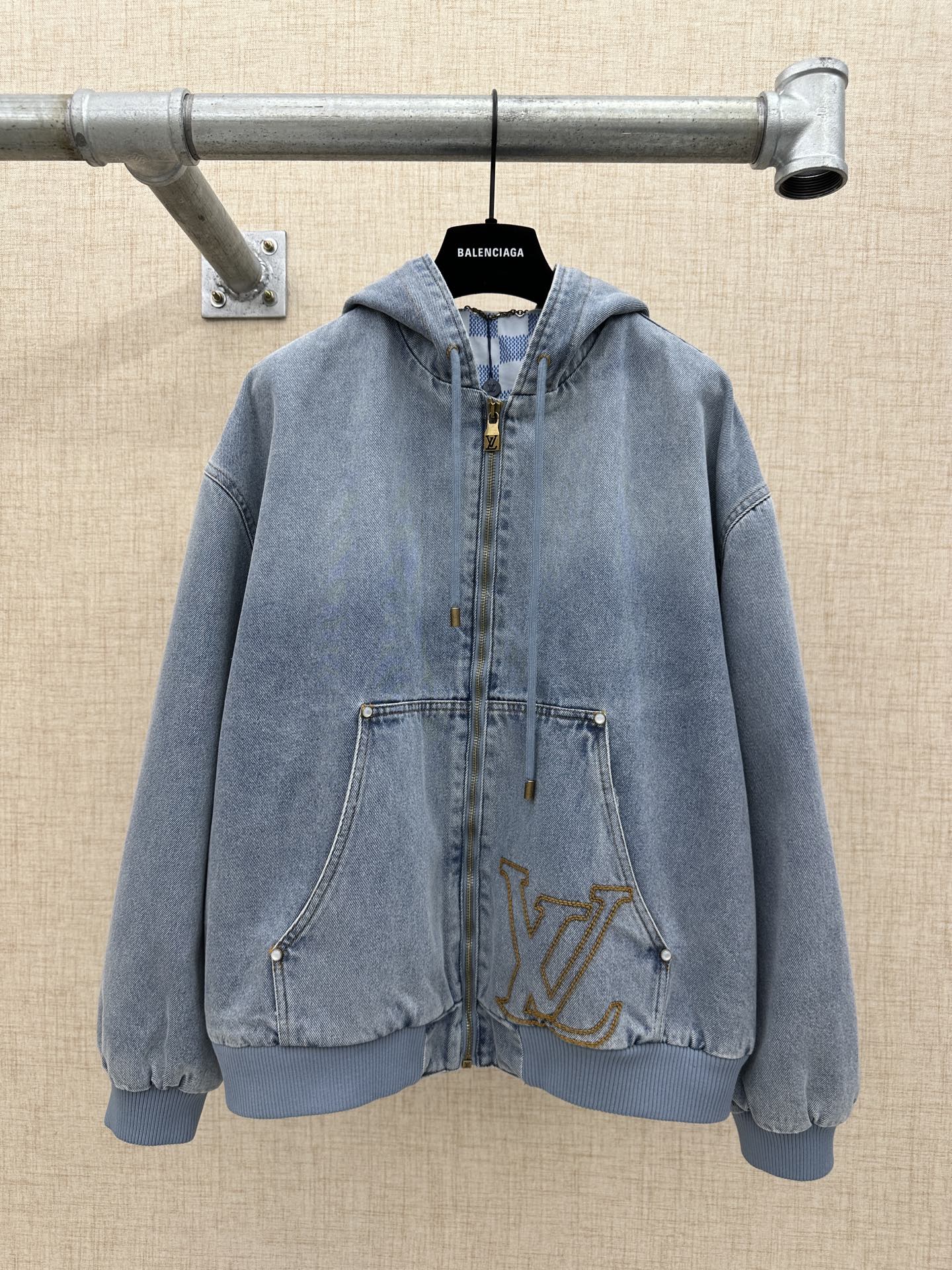 Light blue denim zip-up hoodie jacket with hood and front pockets, gold LV logo