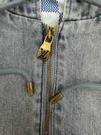 Denim zip-up jacket close-up with gold zipper and LV-logo charm