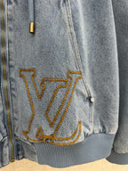 Light blue denim jacket lower front with large gold LV embroidery and ribbed hem