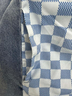 Blue and white checker-pattern fabric panel on long garment
