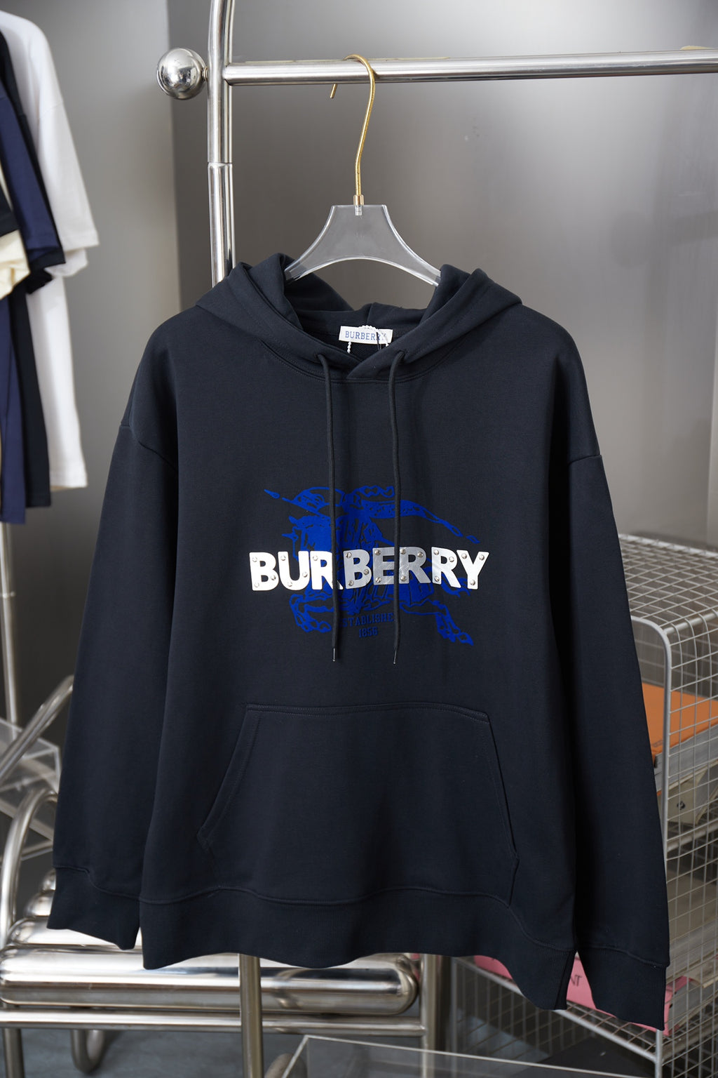 Burberry navy hoodie with hood, front pouch pocket, and blue logo graphic