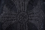 Close-up of black rhinestone graphic detailing on sweatshirt