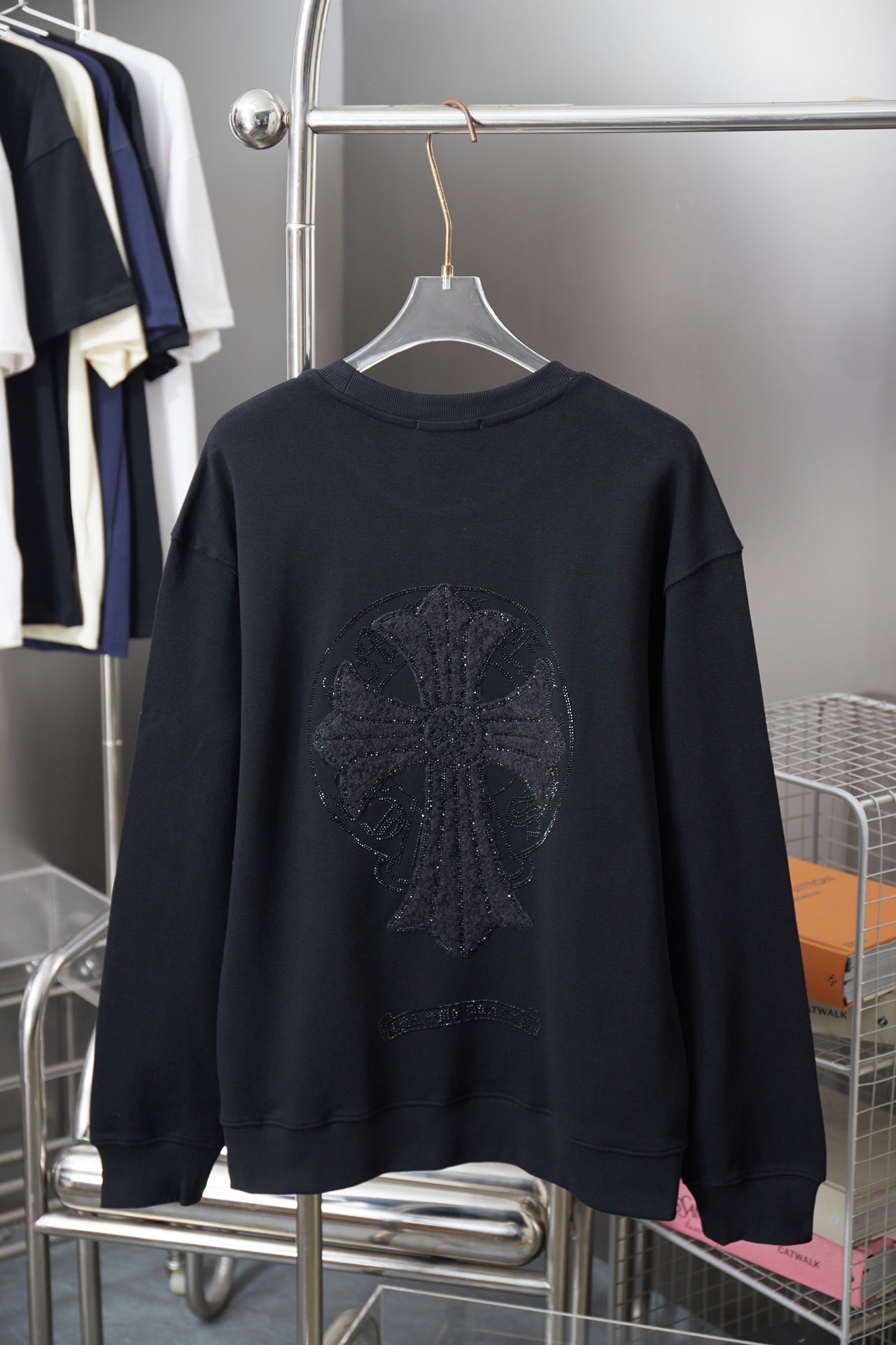 Black long-sleeve crewneck sweatshirt with large rhinestone graphic on back