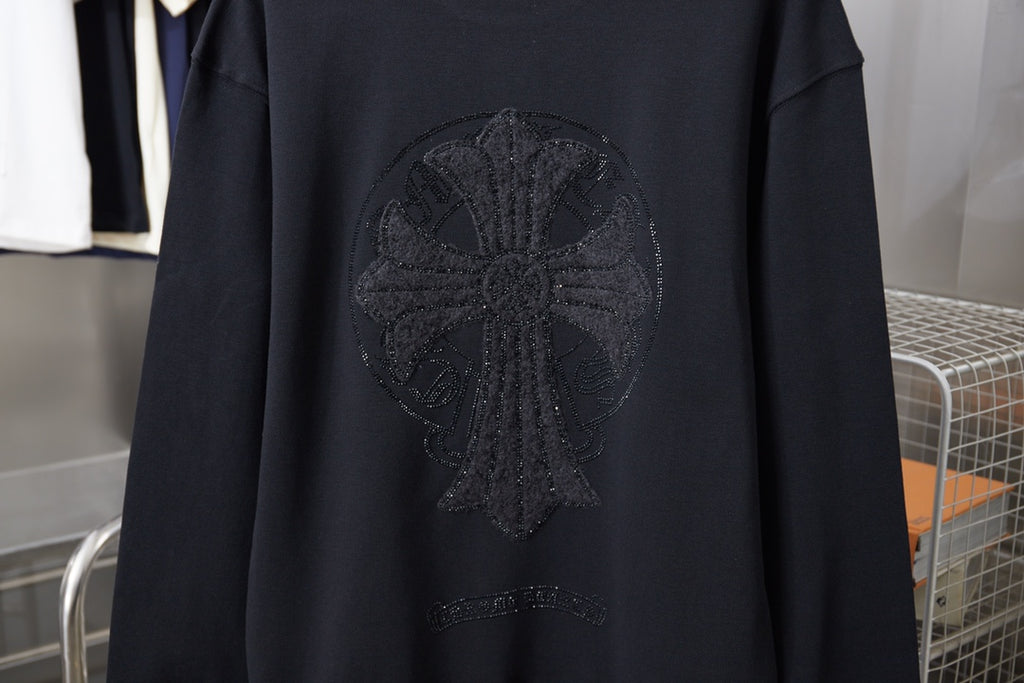Black sweatshirt back with large rhinestone cross-like emblem