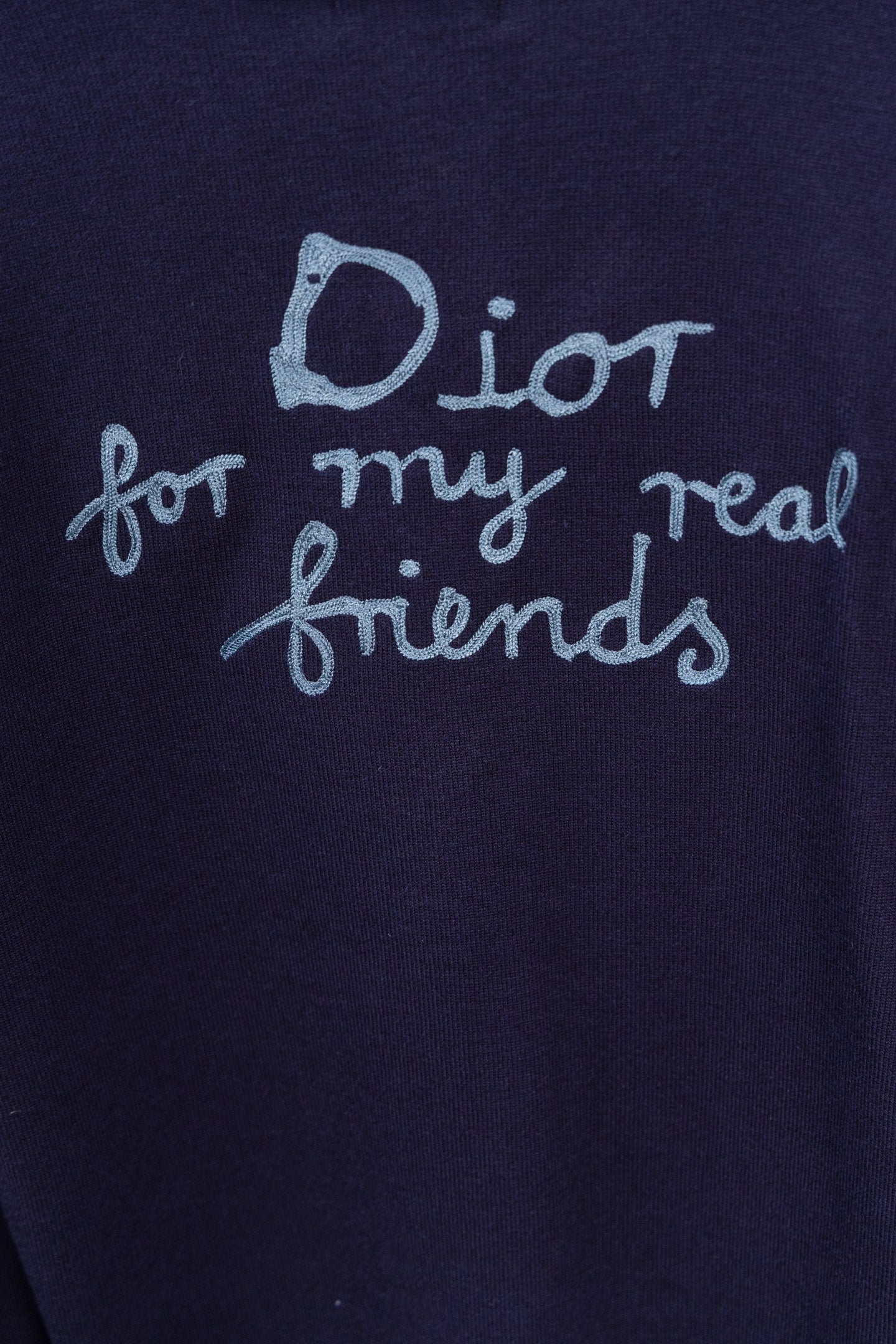 Navy crewneck top close-up with Dior 'for my real friends' print