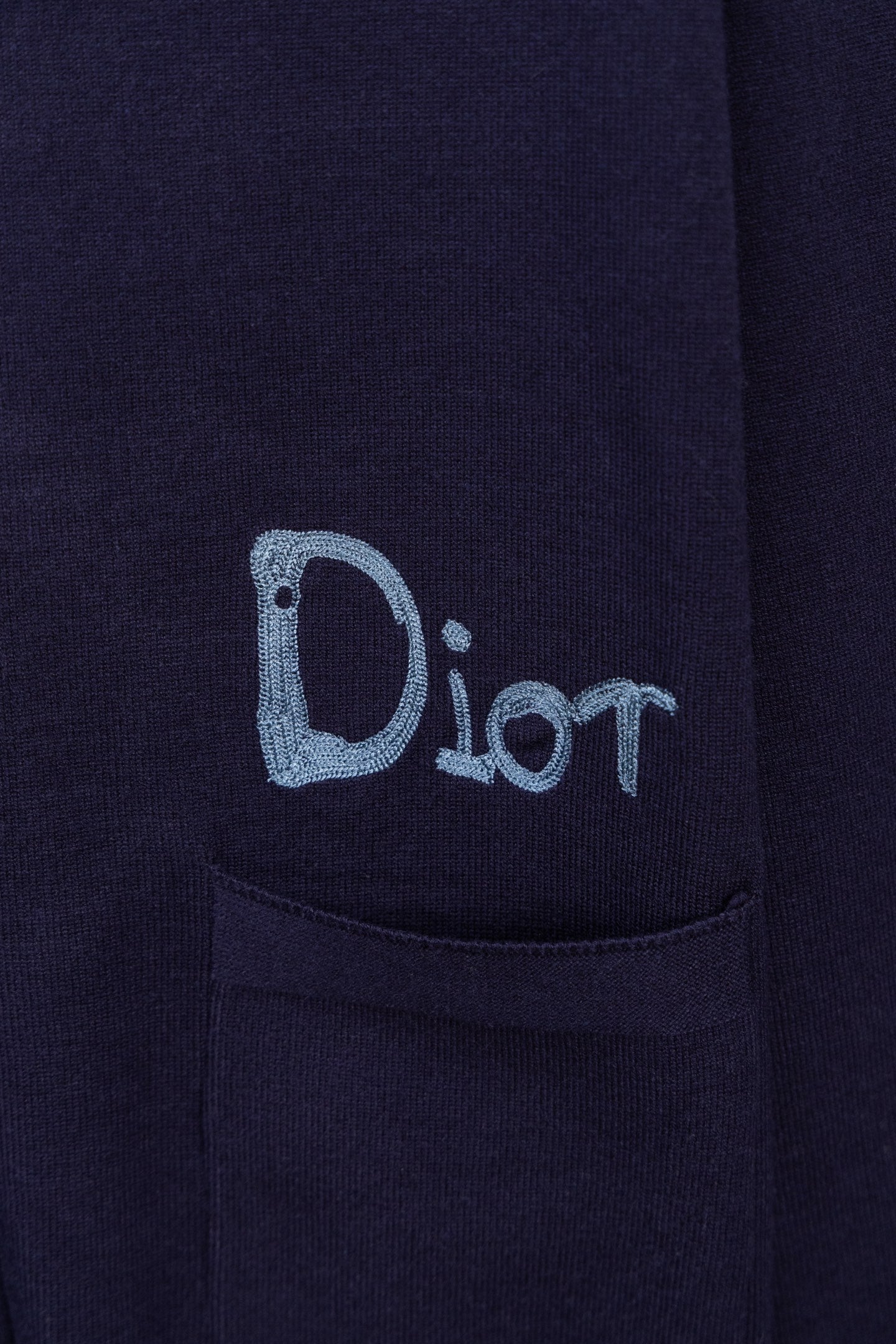 Navy cardigan with blue Dior logo embroidery and front pocket detail