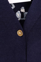 Navy cardigan with gold front button and patterned inner trim