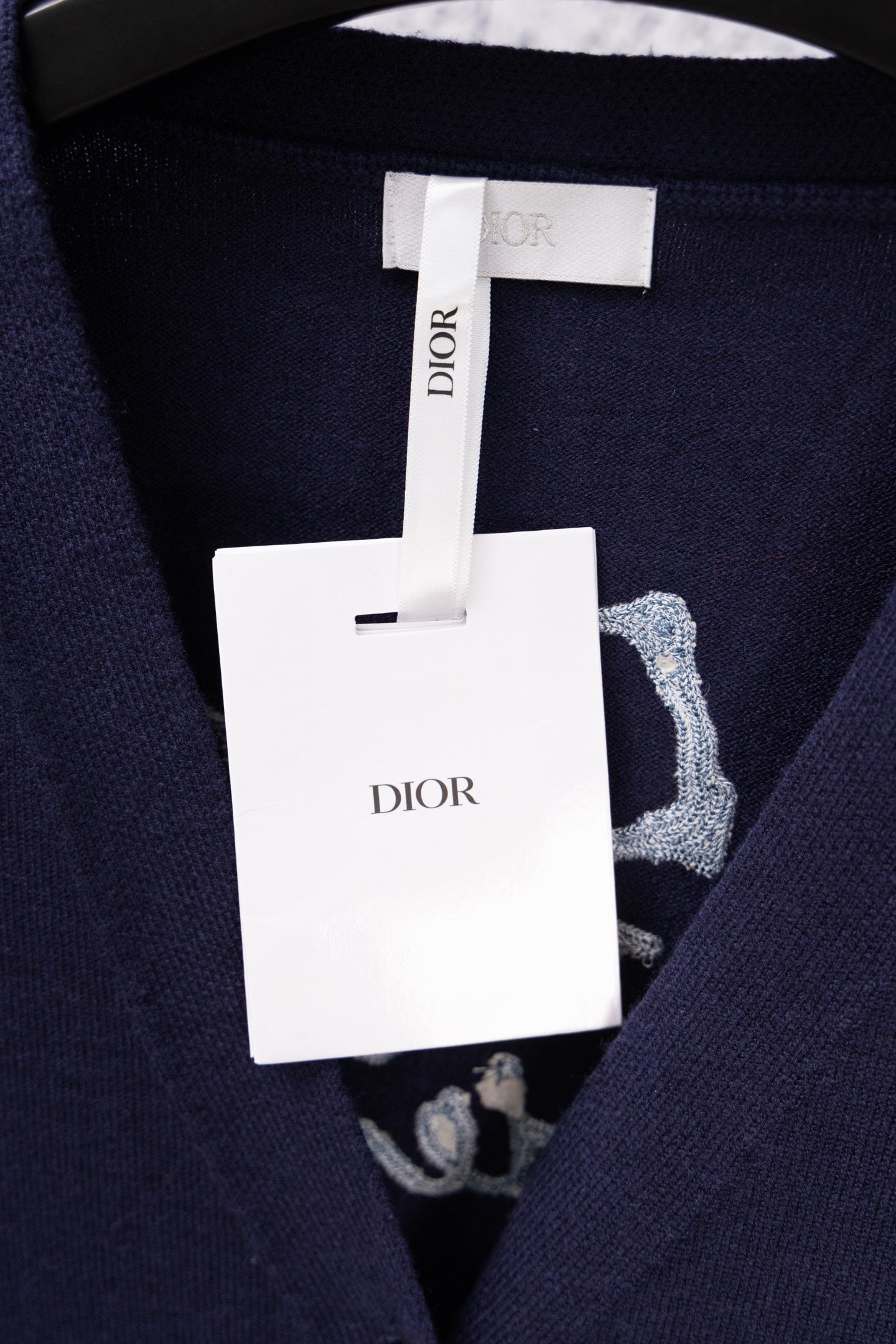Navy cardigan with interior pattern and hanging Dior tag