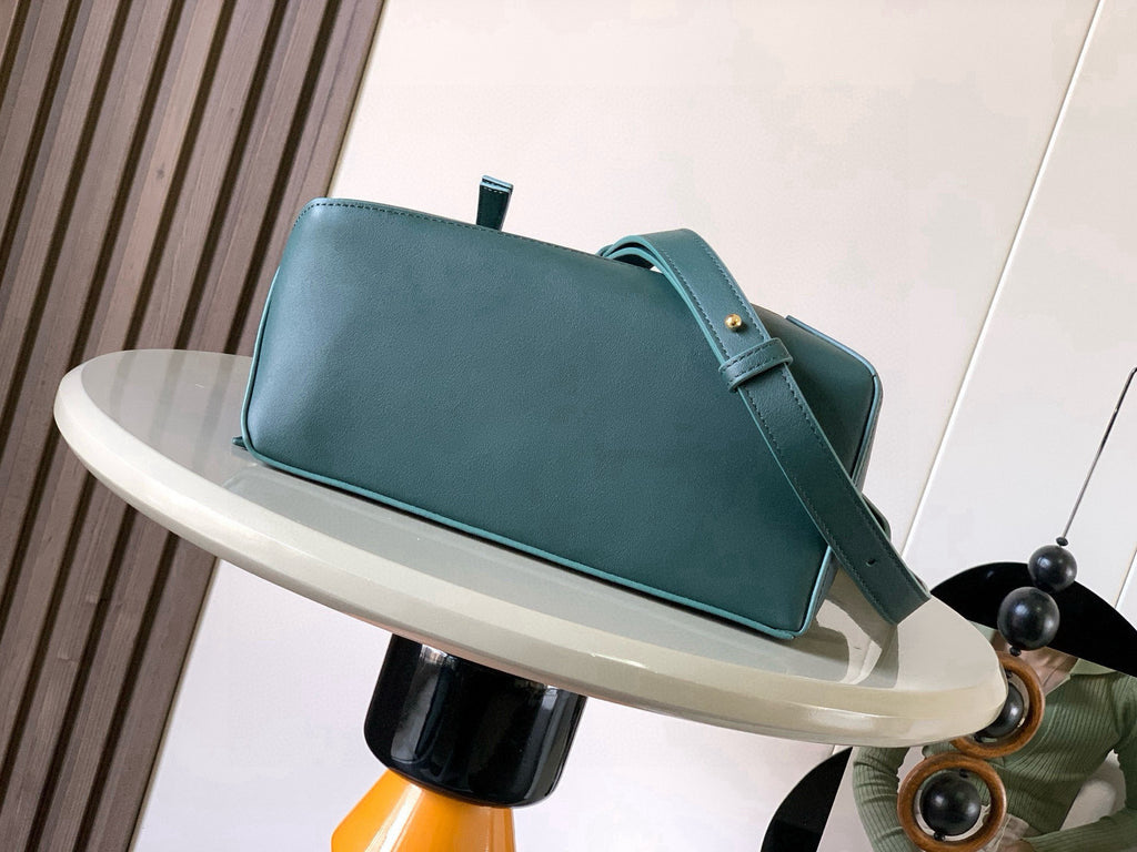 Teal leather rectangular bag with short handle, shoulder strap, and gold studs