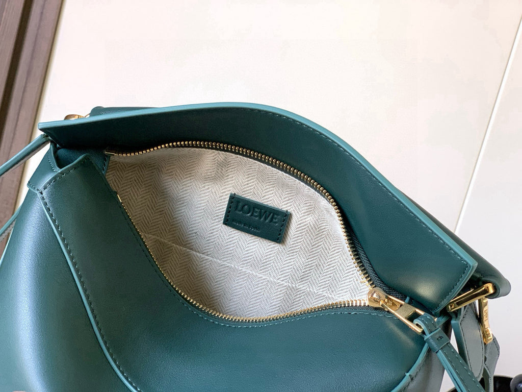 Teal leather bag interior with zipper and LOEWE logo patch at back