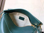 Teal leather bag interior with zipper and LOEWE logo patch at back