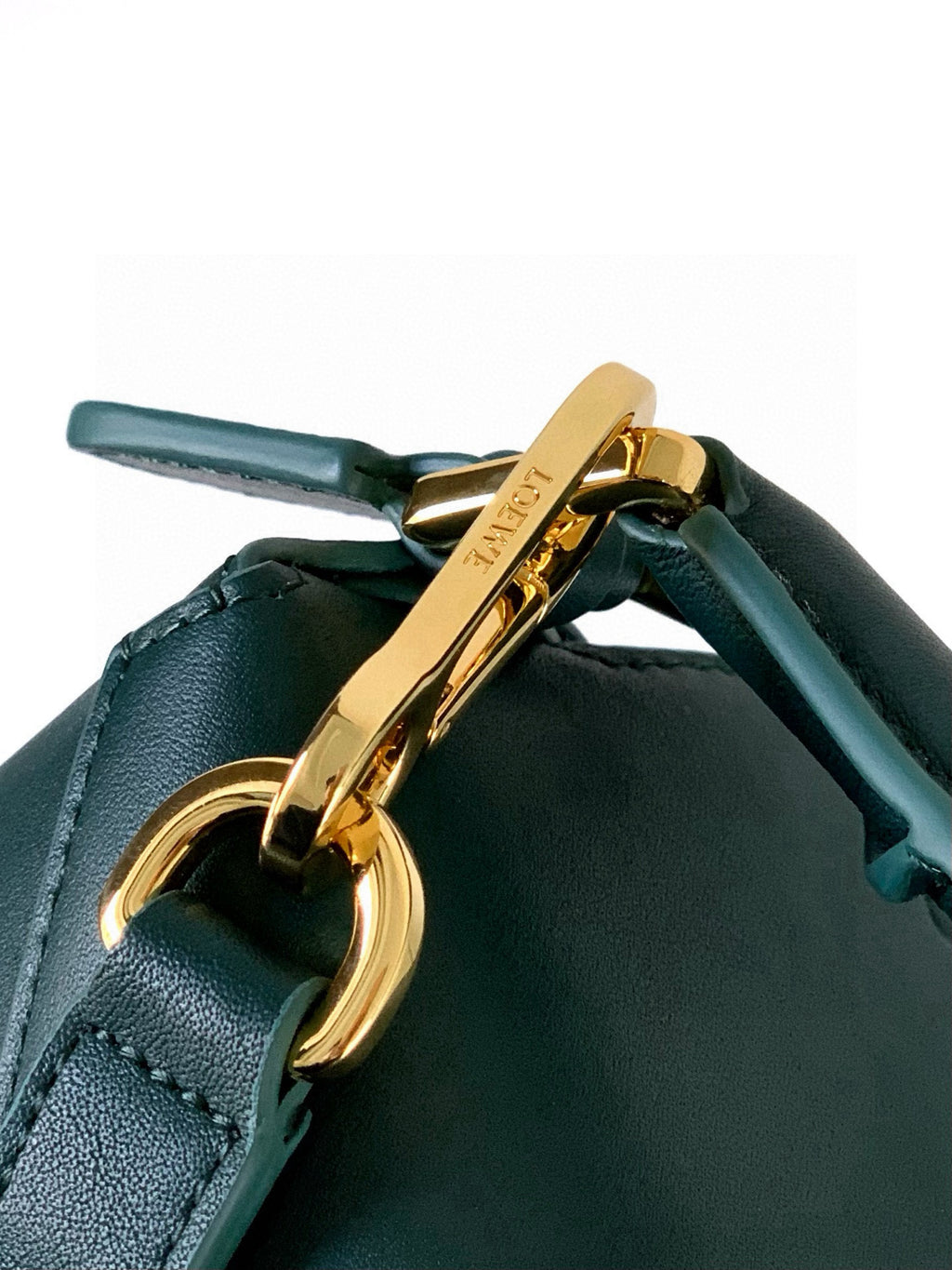Teal leather bag with gold-tone clasp and front ring hardware, close-up