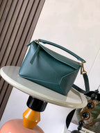 Loewe men’s bag in teal leather, top handle and adjustable shoulder strap