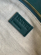 Loewe label on beige herringbone lining inside teal bag
