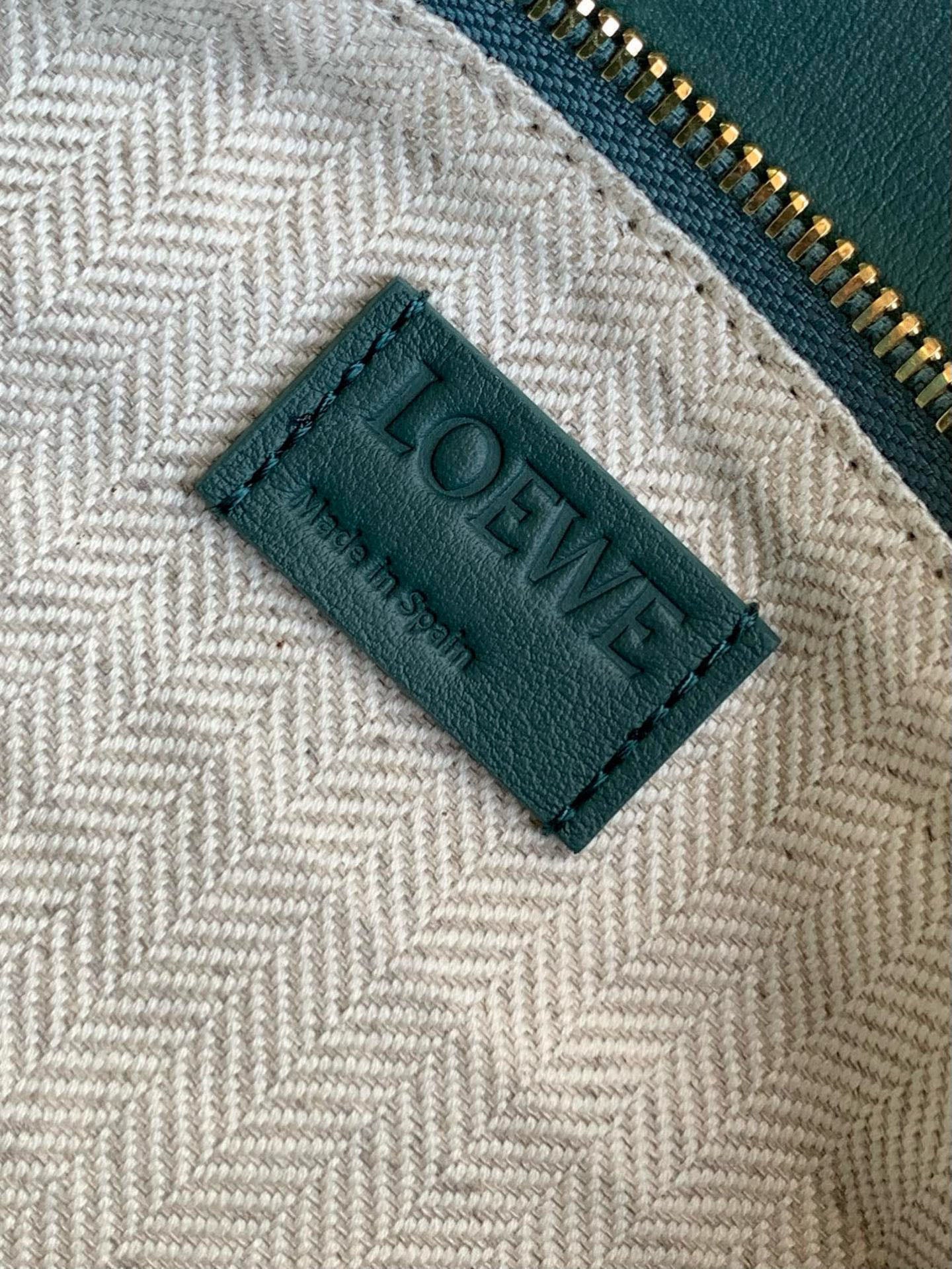 Beige woven lining label with Loewe text and teal trim