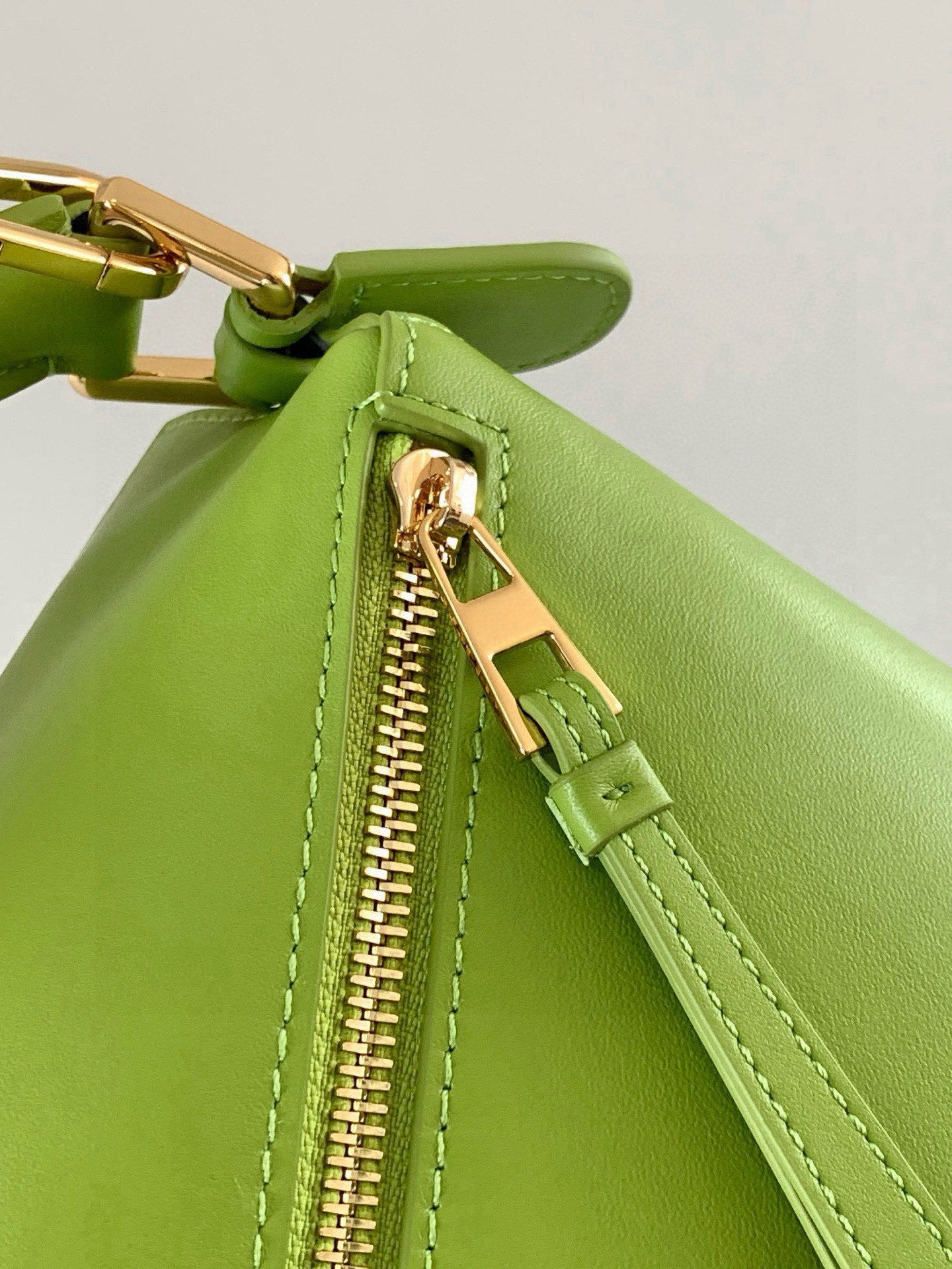 Loewe lime green leather bag zipper with gold-tone pull and stitched edge