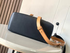Loewe leather baguette bag with long strap, dark navy finish and tan edge trim