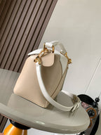 Loewe men’s handbag with top handle, white shoulder strap, and gold buckle hardware