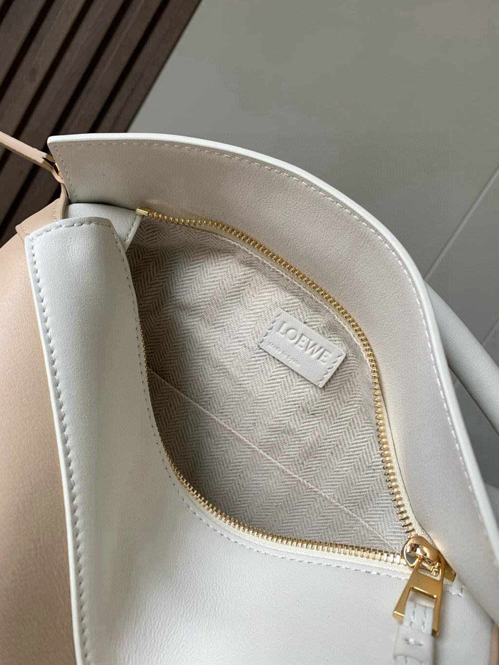 Loewe bag interior pocket with gold zipper and “LOEWE” logo label