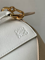 Loewe bag close-up: embossed logo on light beige leather-look panel