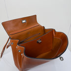 Balenciaga leather bag open view with interior compartments and metal snap hardware