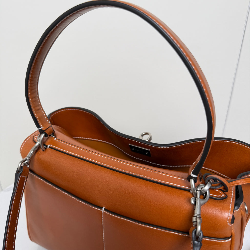 Balenciaga leather bag interior view with top opening, stitched trim, and metal strap hardware