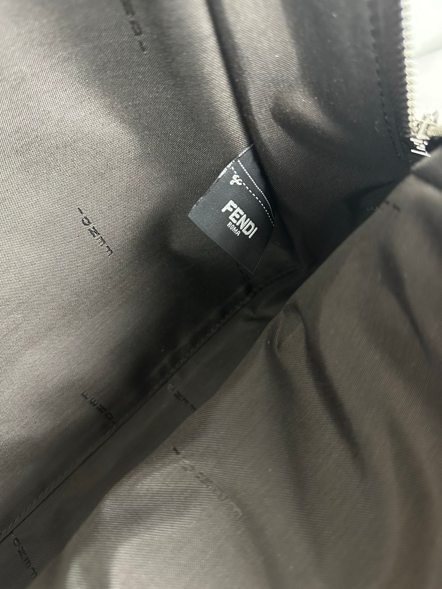 Fendi bag interior lining with Fendi label and zipper seam close-up