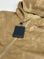 Louis Vuitton tan hooded jacket close-up with repeating monogram pattern and hang tag