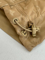 Louis Vuitton tan jacket sleeve cuff close-up with drawstring cord and zipper pull
