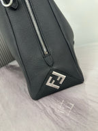Fendi dark leather bag corner with metal zipper pull and FF logo patch
