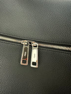 Fendi logo-engraved zipper pull tabs on dark leather bag